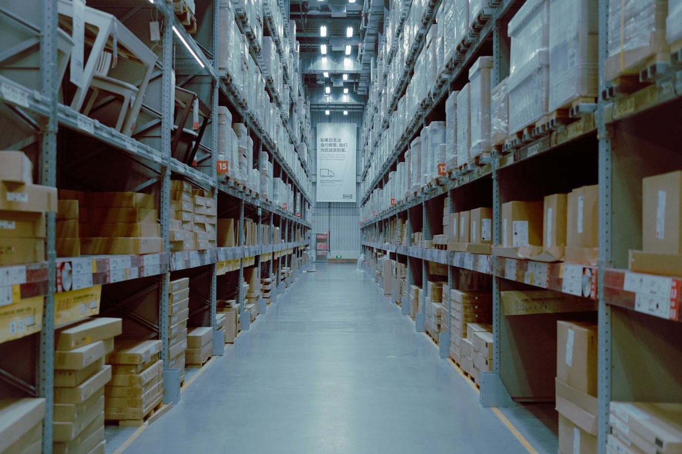 A large warehouse with rows of stocked shelving